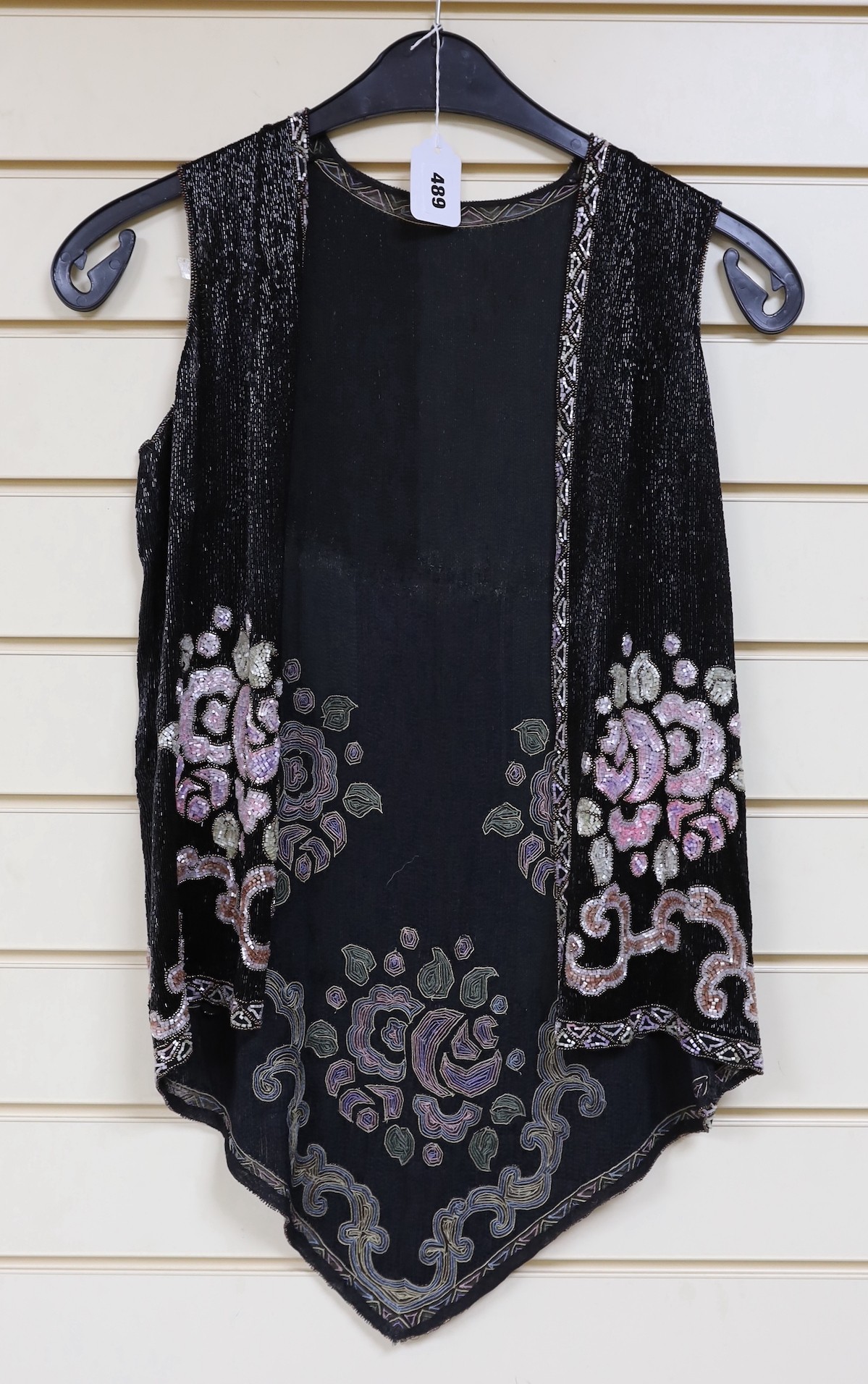 A 1920's multi-coloured beadwork sleeveless evening jacket